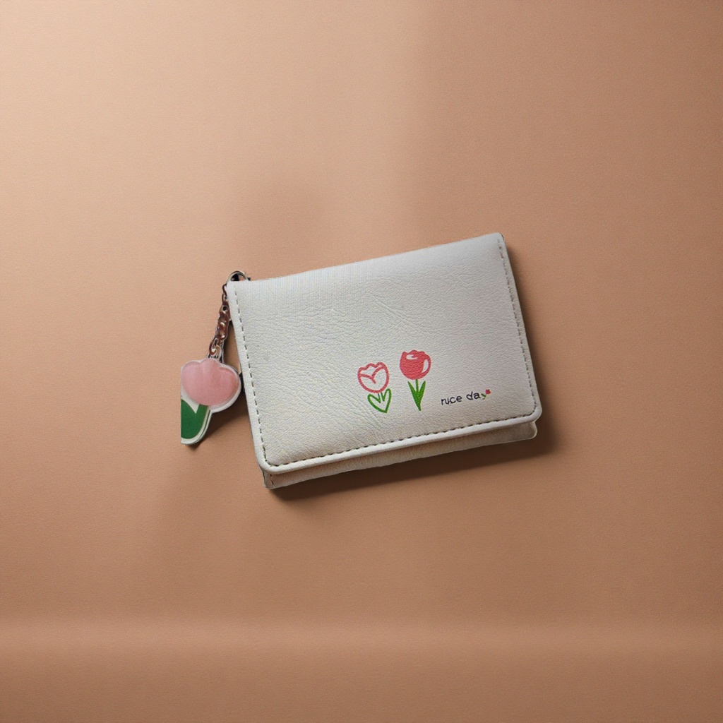 A small white wallet is printed with two red tulips and a nice day with a pink heart-shaped pendant