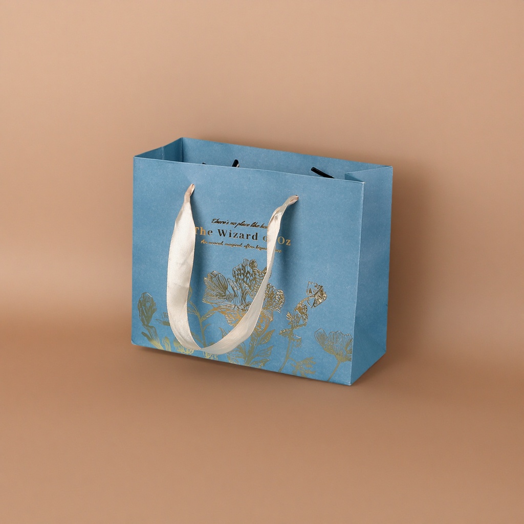 A blue gift bag with a beige ribbon handle featuring golden floral patterns Application Scenario