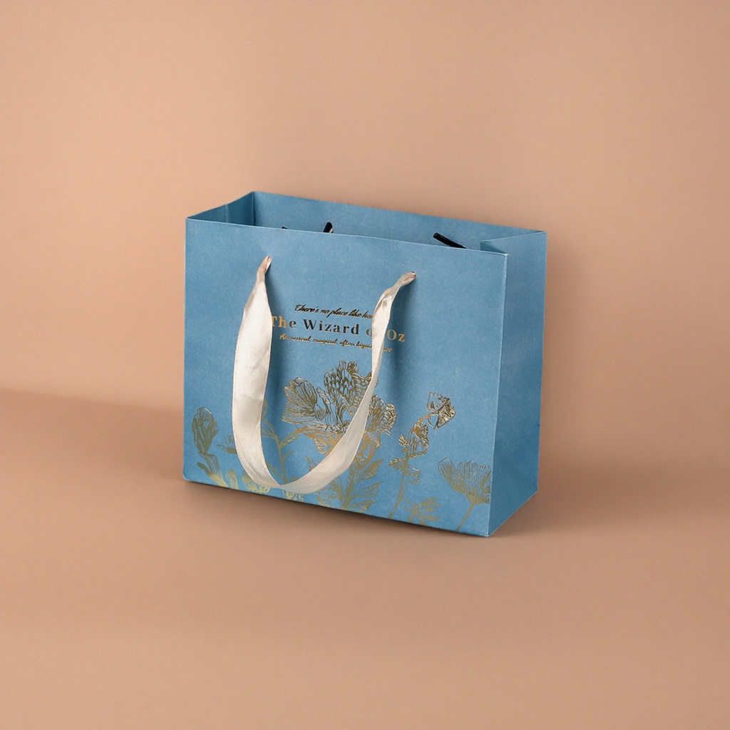 A blue gift bag with a beige ribbon handle featuring golden floral patterns Specification image