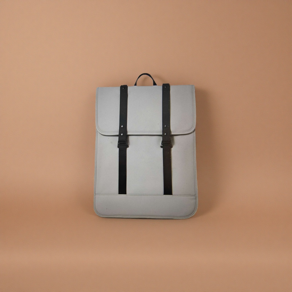 Light grey backpack strap, black leather strap and handle