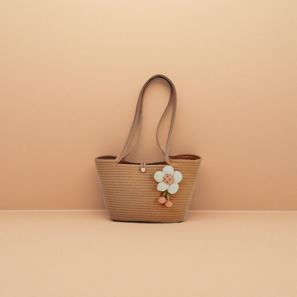 The beige woven handbag is decorated with white flowers and orange flower buds Specification image