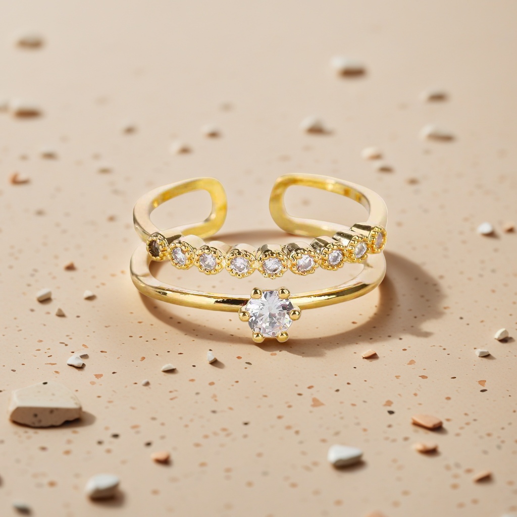 The golden double-layered ring features multiple round transparent gemstones on the upper layer and a large round transparent gemstone in the center on the lower layer. It has a white stone countertop