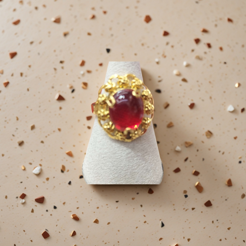 A golden carved ring with red gemstones is fashionable, simple and versatile for women