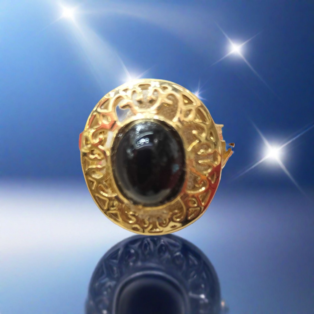 A fashionable and light luxury lady's ring with a golden carved pattern and a black oval gemstone set in the center details Picture