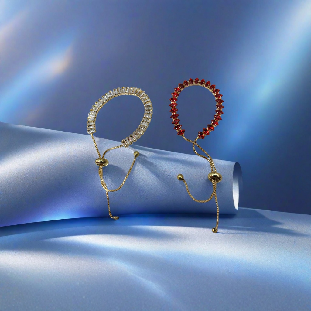 The golden diamond-encrusted bracelet features a transparent rectangular crystal on the left and a red teardrop gemstone on the right, with a golden adjustable chain bead clasp
