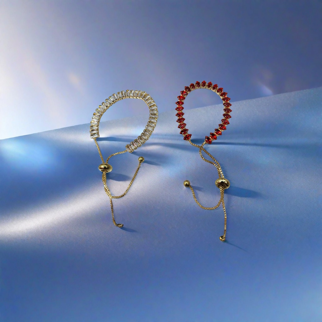 The golden diamond-encrusted bracelet features a transparent rectangular crystal on the left and a red teardrop gemstone on the right, with a golden adjustable chain bead clasp details Picture