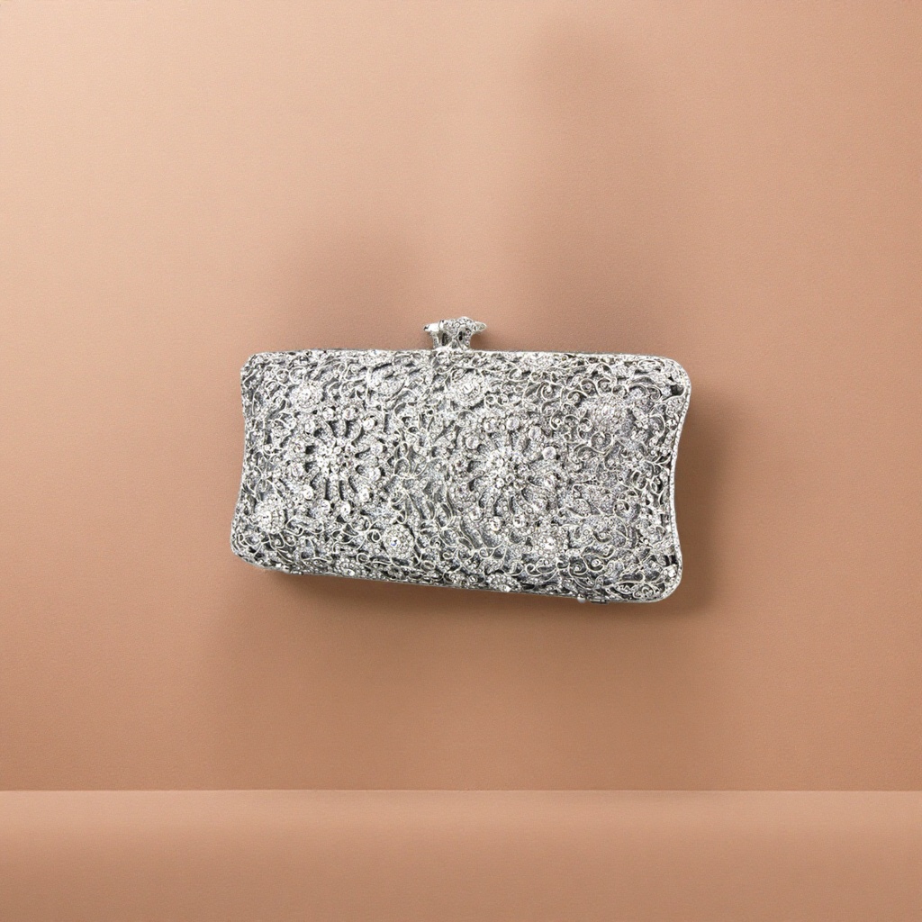 The silver diamond-encrusted and carved clutch is small and portable for ladies' dinner parties