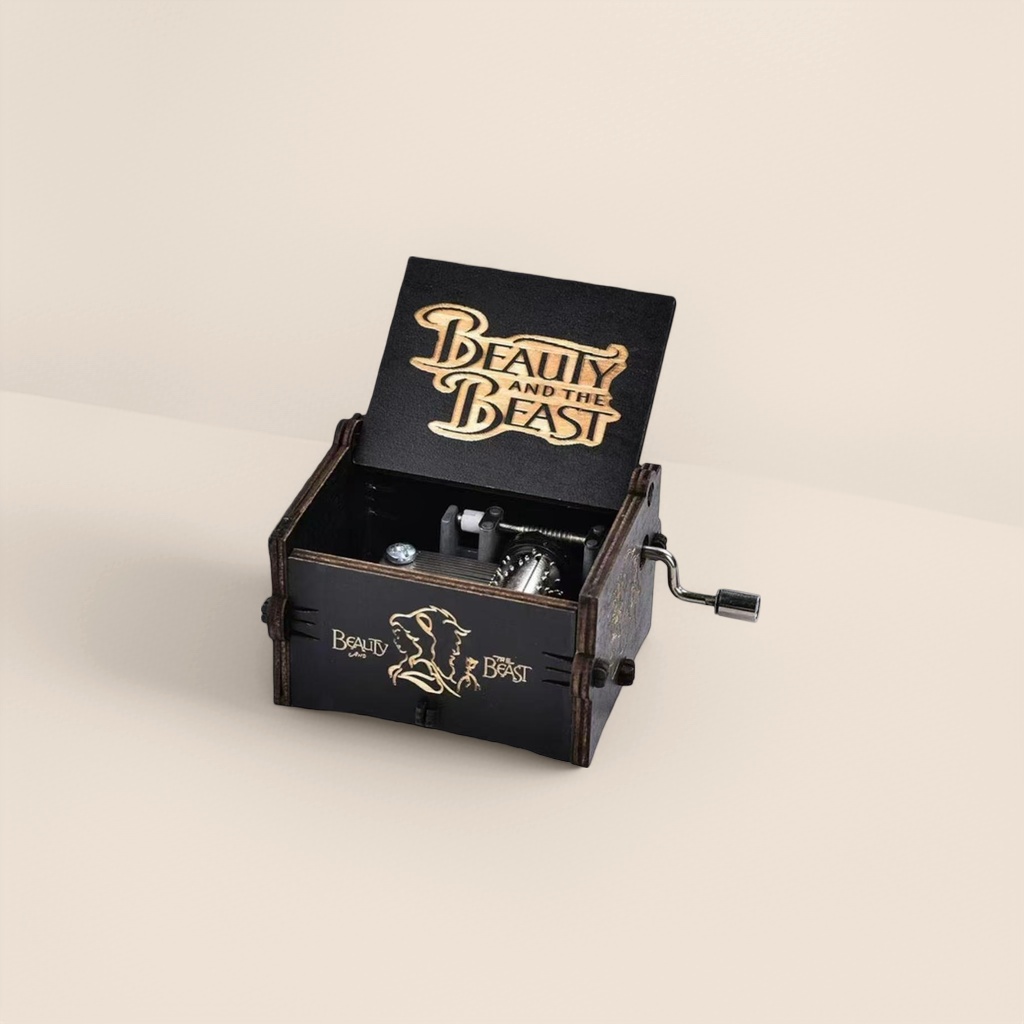 THE lid of the black wooden music box is engraved with the words "BEAUTY AND THE BEAST" in gold. The silhouette of Belle the Beast on the side is paired with a metal hand crank