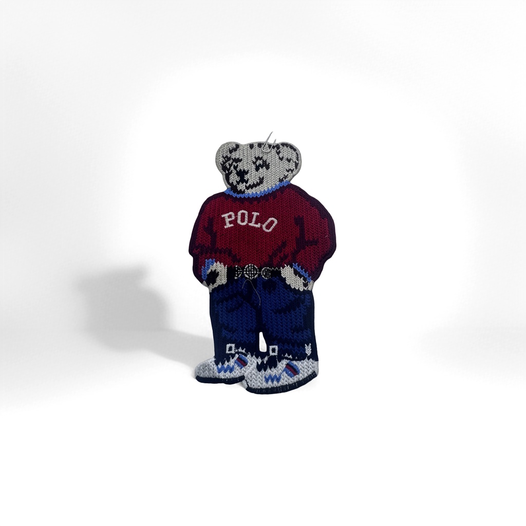 A cute knitted bear-shaped badge with a plush texture and a metal pin as an adorable accessory details Picture