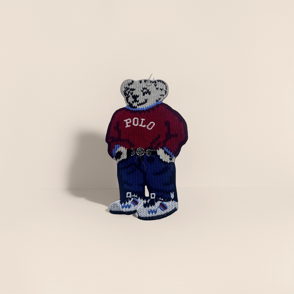 A cute knitted bear-shaped badge with a plush texture and a metal pin as an adorable accessory Specification image