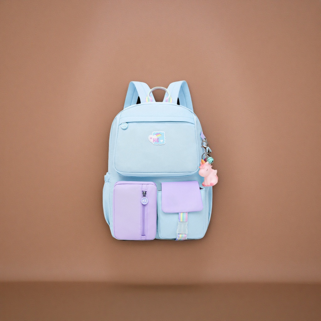 A light blue backpack with a purple unicorn pendant in the front pocket details Picture