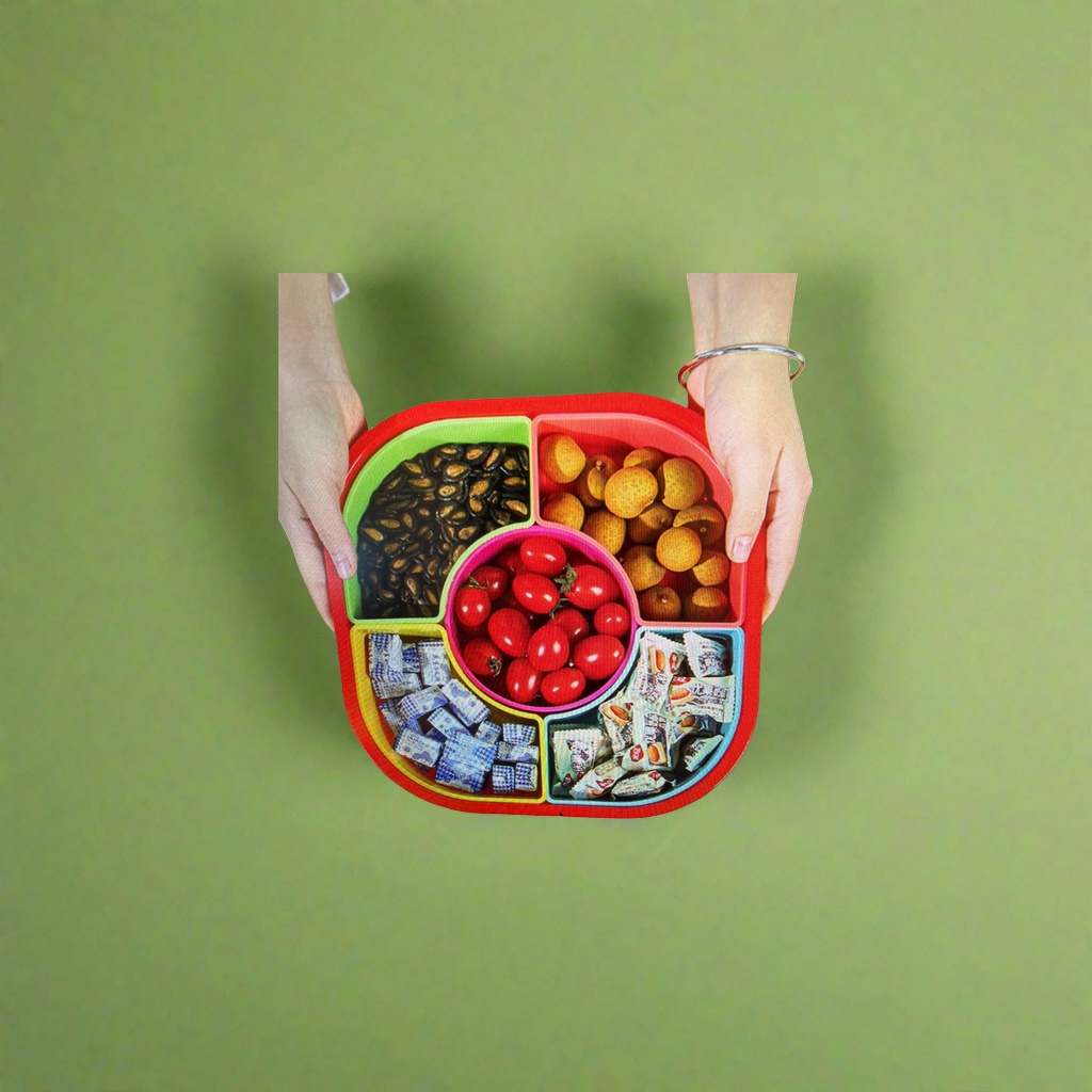 The colorful compartmented fruit plate contains black melon seeds, longans, cherry tomatoes, blue and white packaged candies, and white packaged snacks details Picture