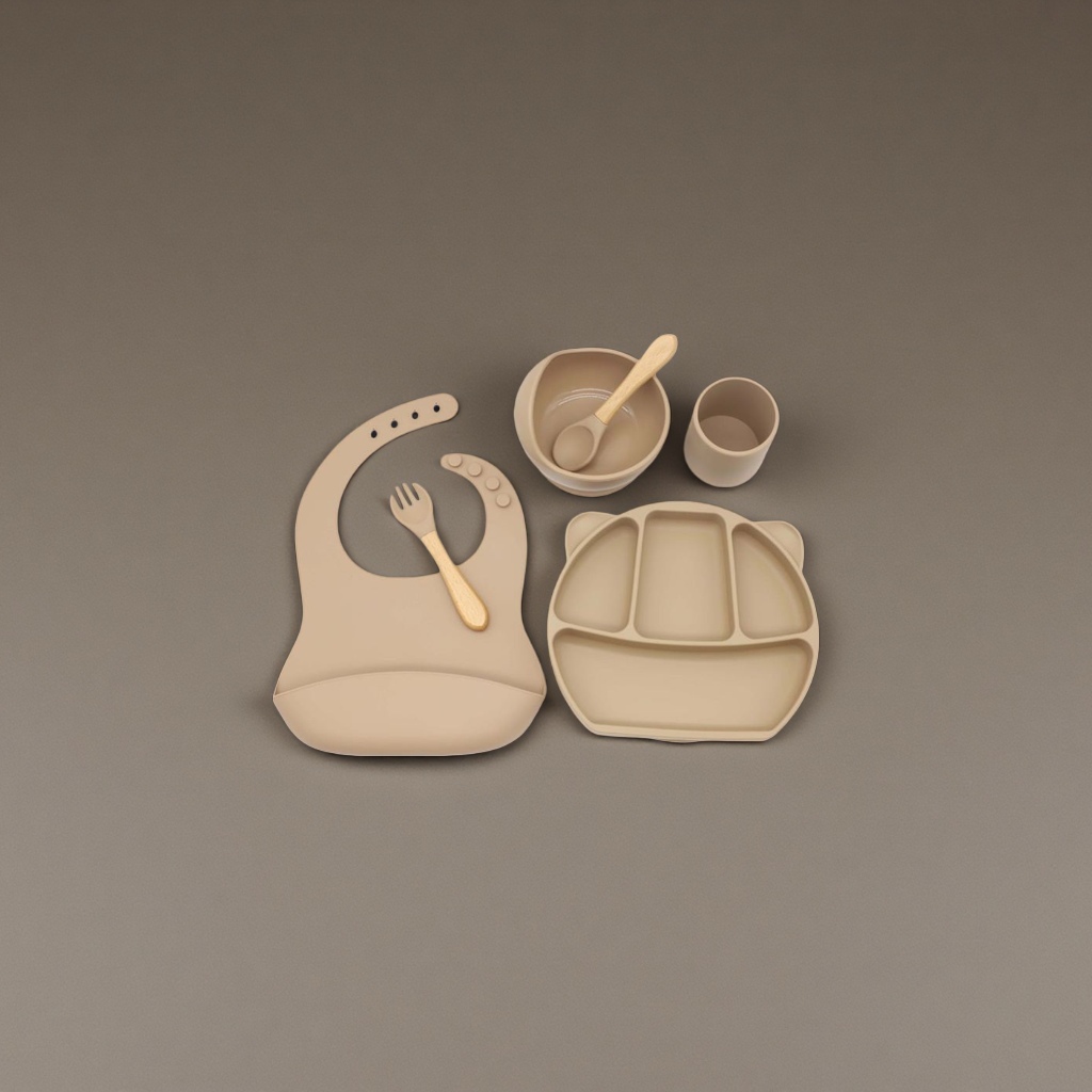 Beige silicone baby tableware set with bibs, compartments, plates, bowls and cups, and wooden handles