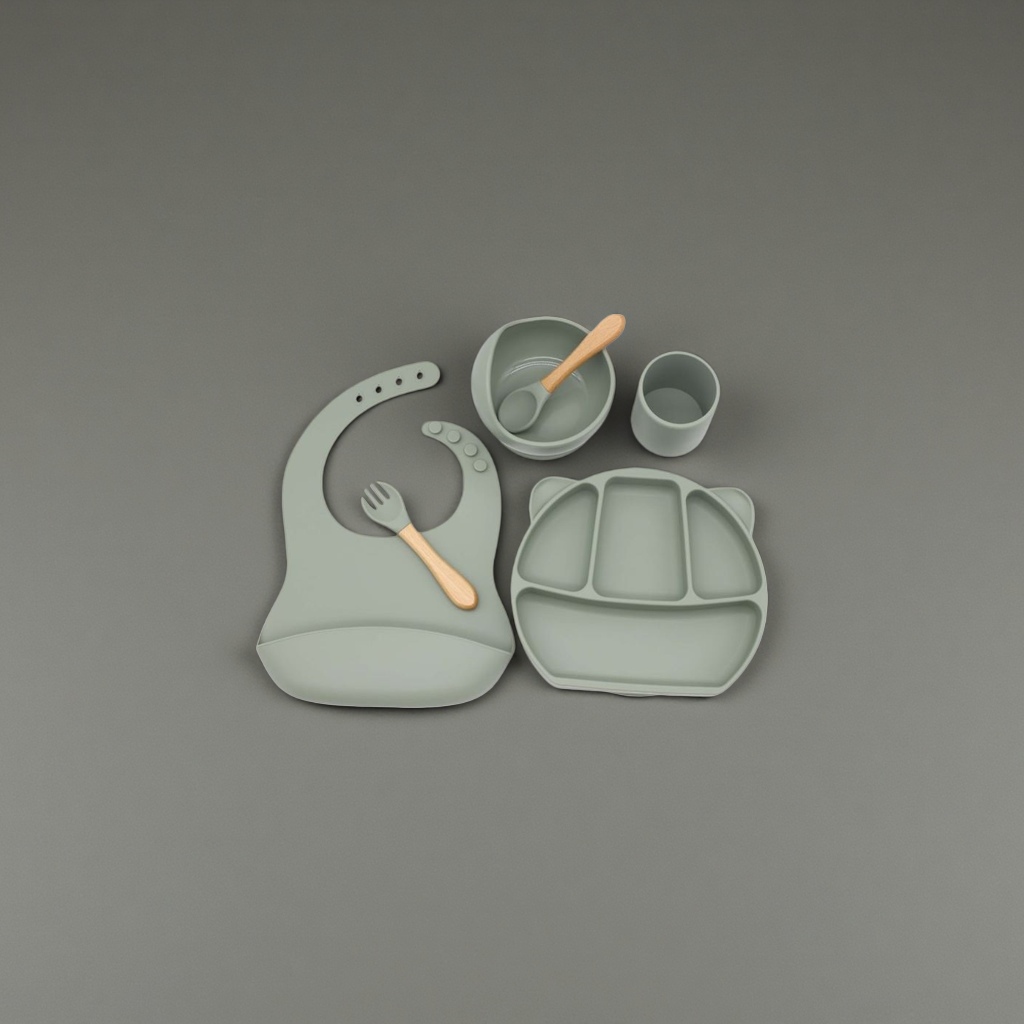 Green silicone baby tableware set with bibs, compartments, plates, bowls, cups, wooden handles, forks and spoons