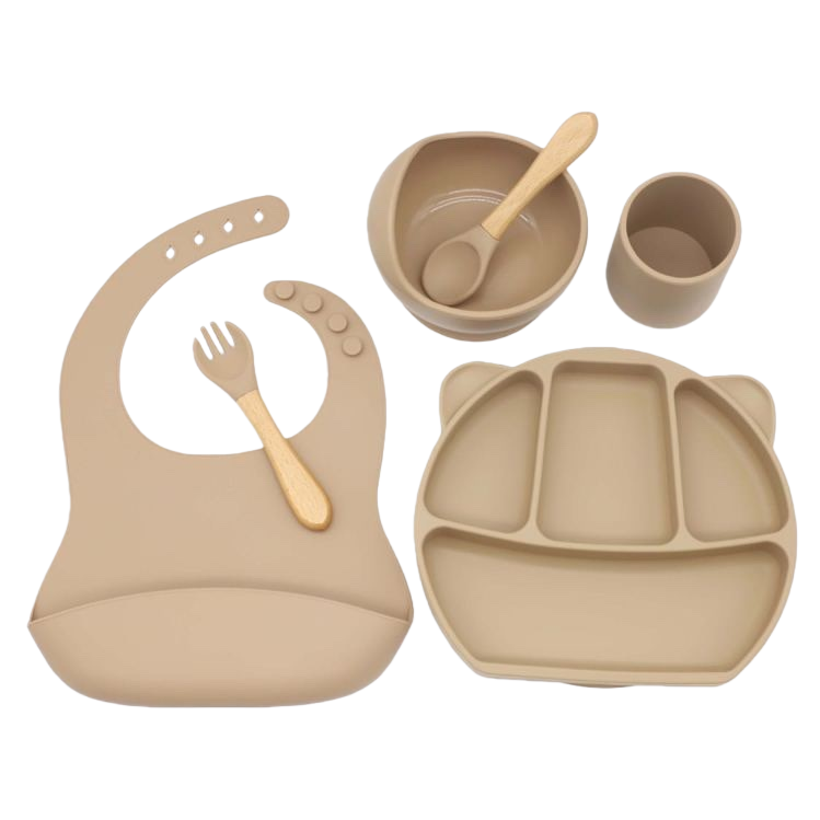 Beige silicone baby tableware set with bibs, compartments, plates, bowls and cups, and wooden handles Item Picture