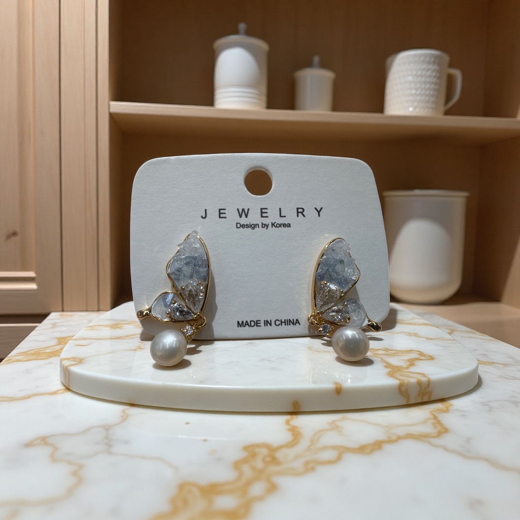 Golden butterfly-shaped stud earrings are inlaid with transparent crystals and pearls and come with white labels Application Scenario