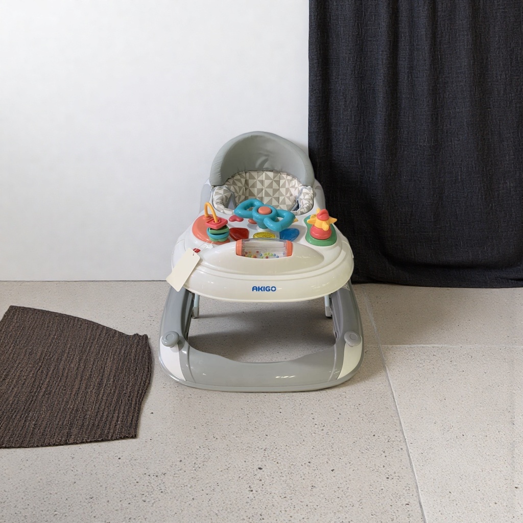 The baby walker has a white body with colorful toys, adjustable height, and is stable and safe