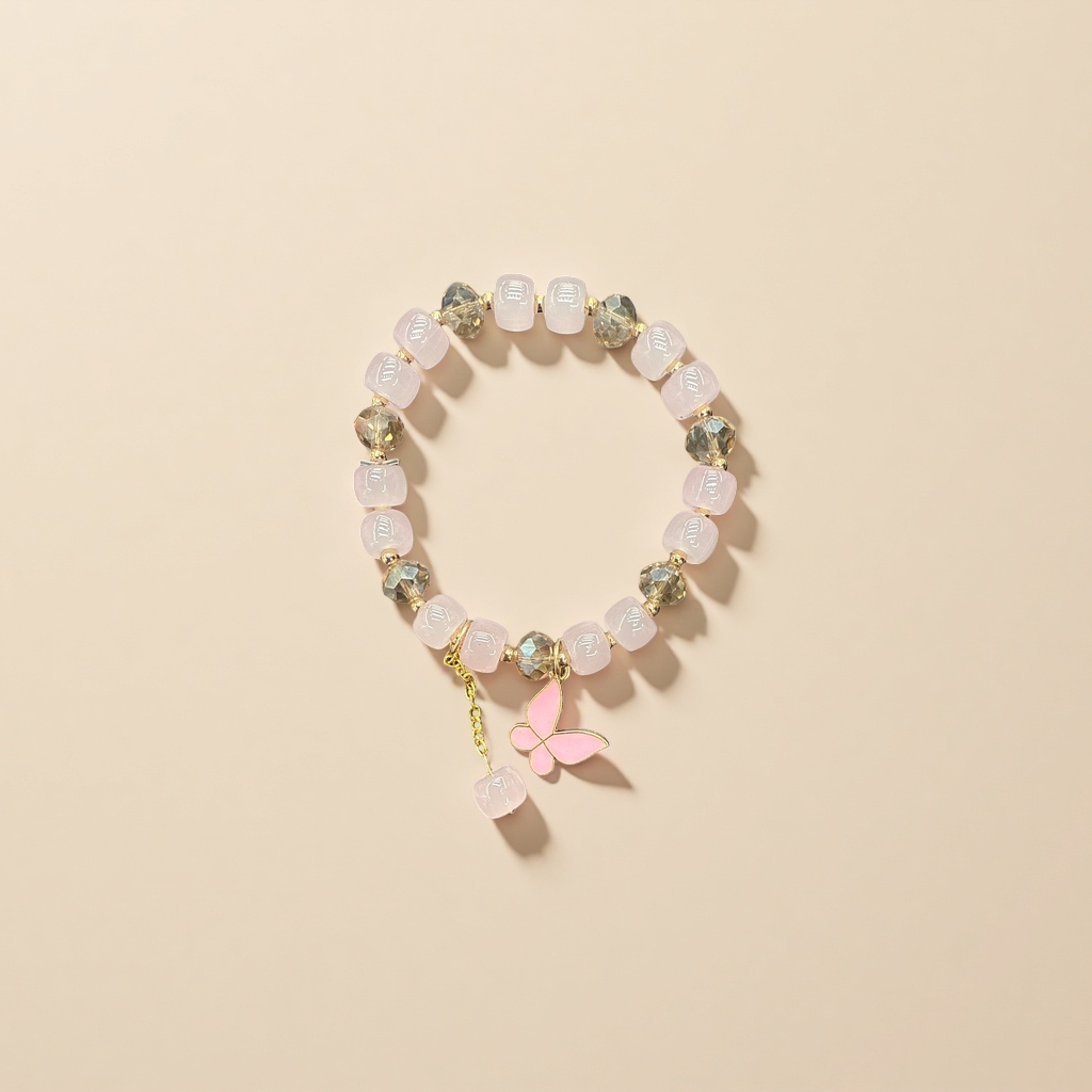A pink beaded bracelet with a golden butterfly pendant is a fashionable and simple ladies' accessory details Picture
