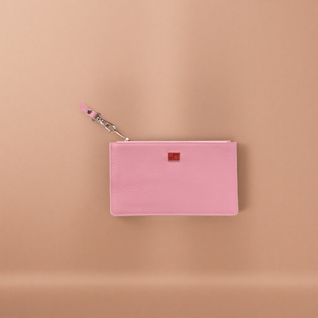 A pink textured clutch bag with a metal buckle and a lanyard, a fashionable small ladies' bag