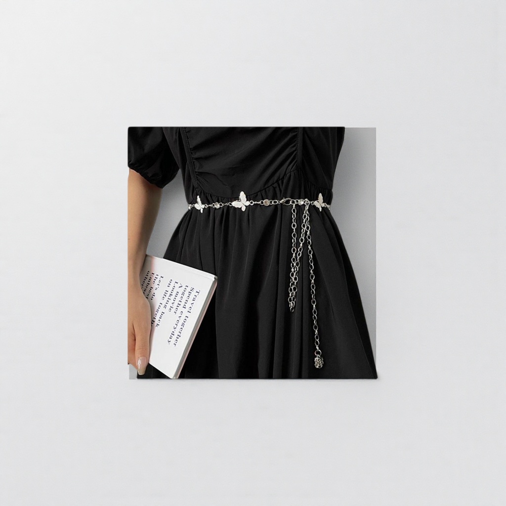 The silver butterfly chain belt paired with a black dress is fashionable, form-fitting and slimming