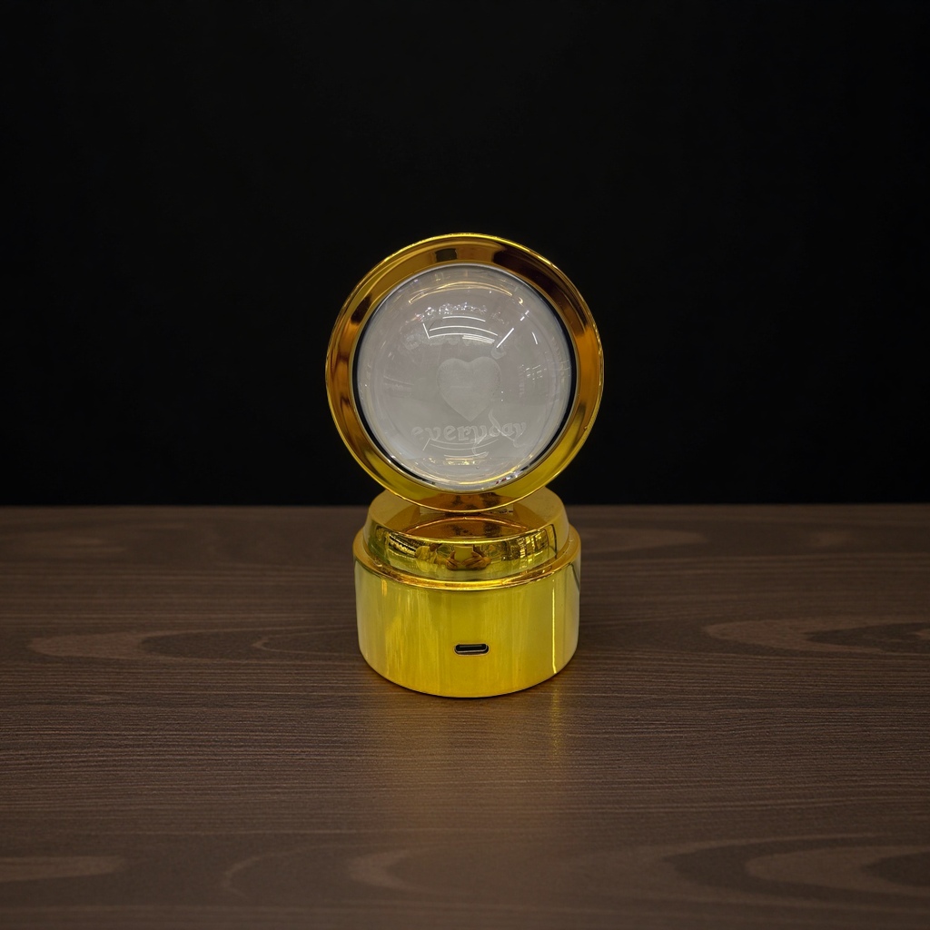 The golden base and transparent sphere are engraved with heart-shaped patterns and the words "everyday" details Picture