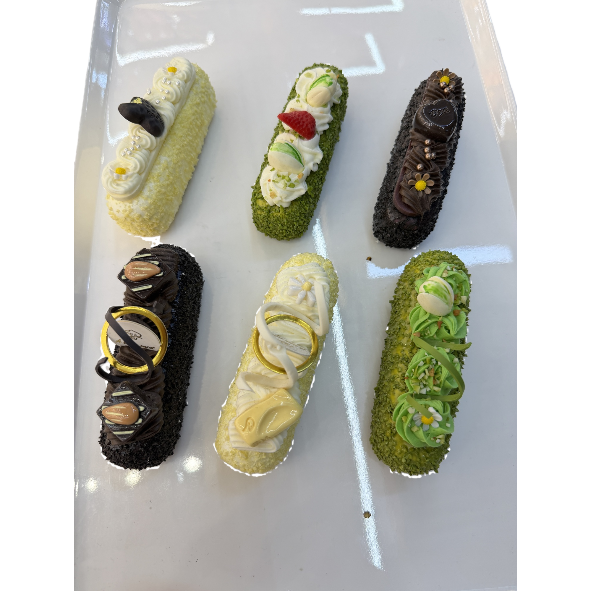 A set of six exquisite desserts and pastries on a white plate Item Picture