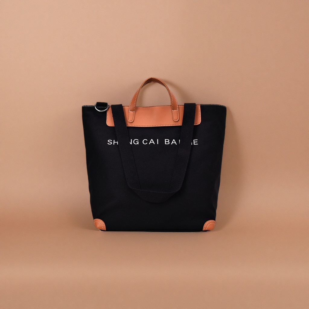 Black canvas tote bag, brown leather handbag, corner white SHANG CAI BA letters