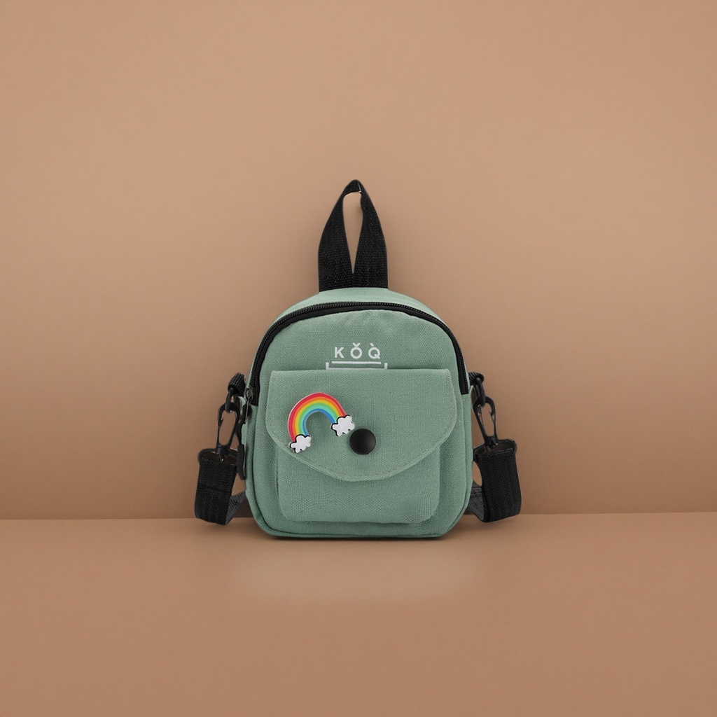 The green canvas small backpack has a rainbow cloud badge on the front, a black snap button and a black shoulder strap handle Application Scenario