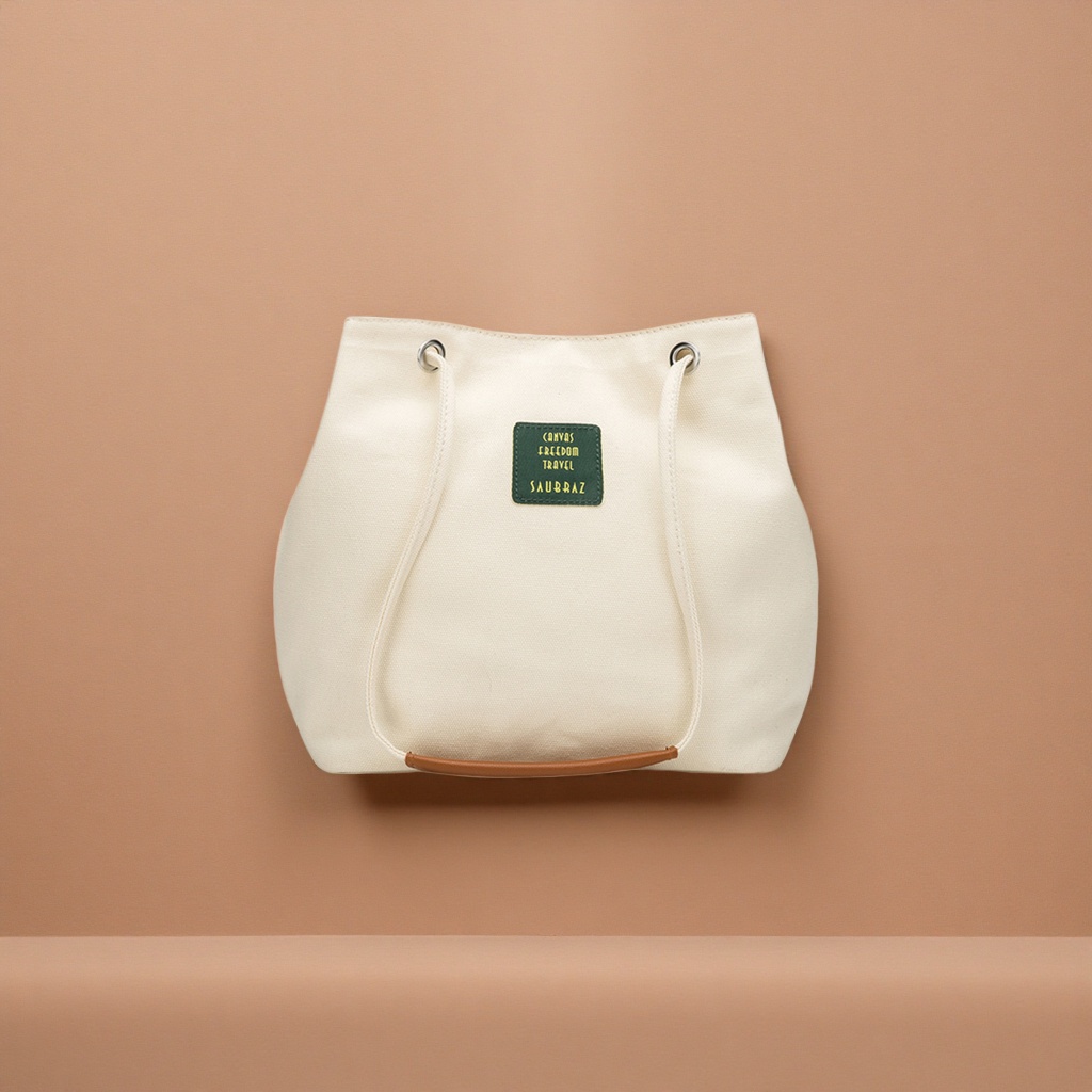 The off-white canvas bag is a simple, versatile, hand-held and shoulder-carrying commuter casual lady's bag