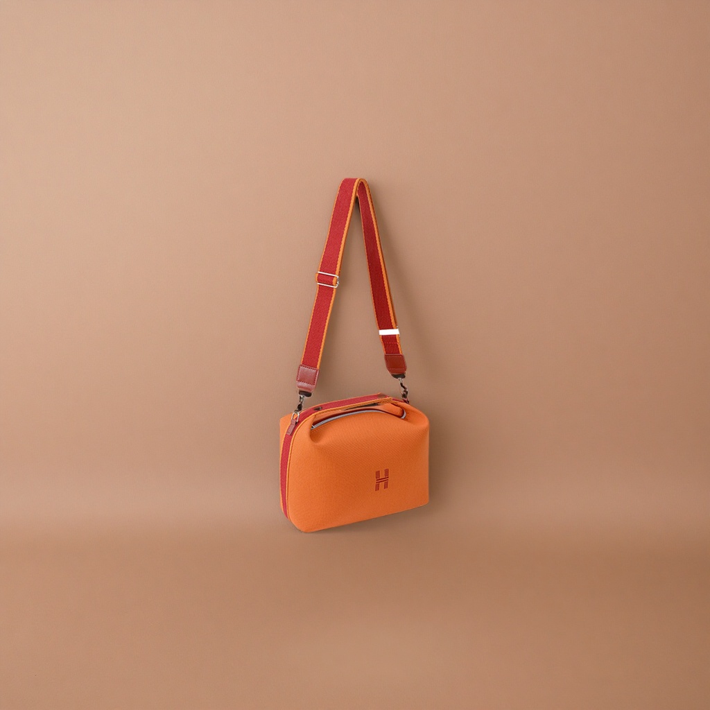 A fashionable women's single-shoulder bag with an orange handbag and a red striped shoulder strap Application Scenario
