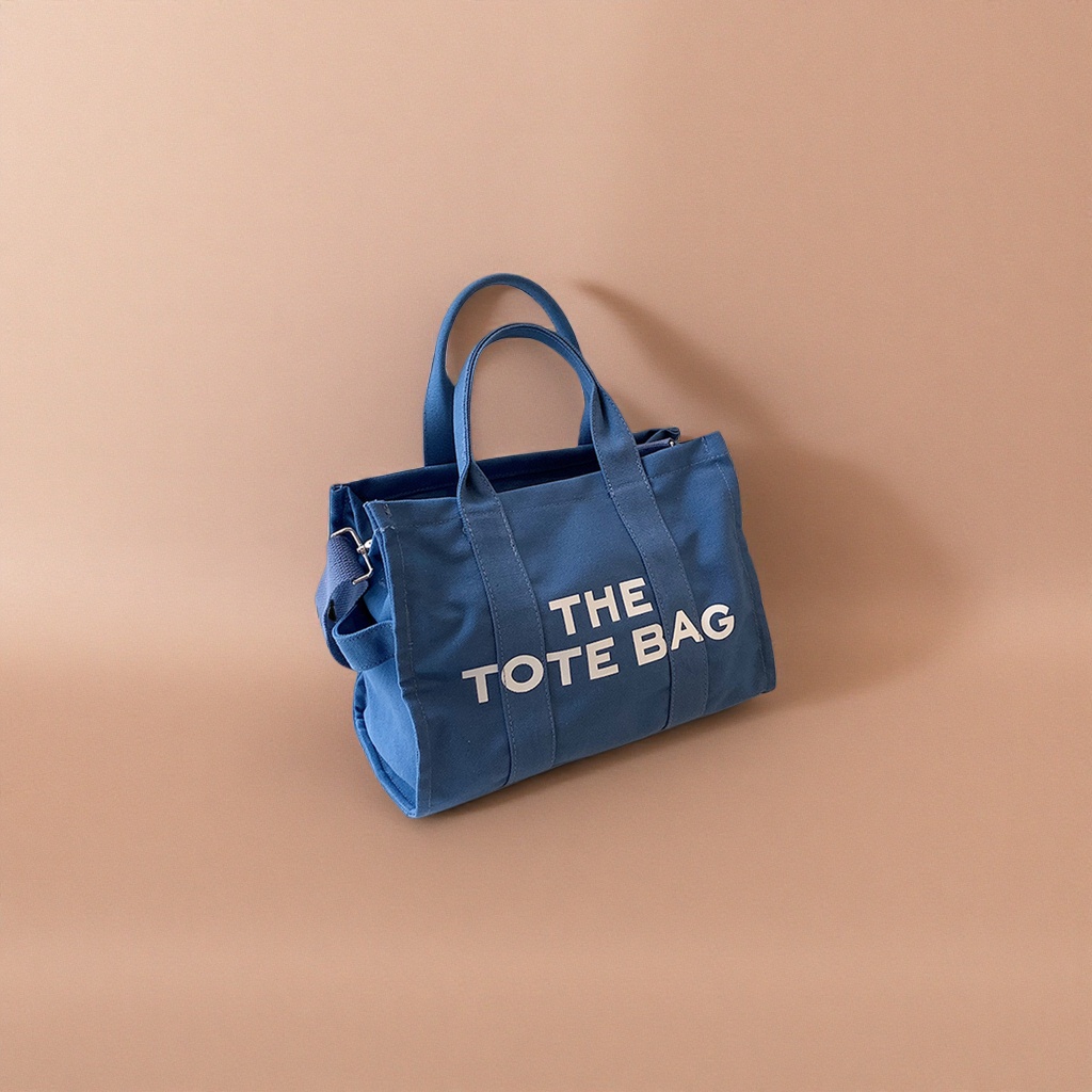 The blue canvas tote bag is a large-capacity commuting shopping handbag that is simple and versatile