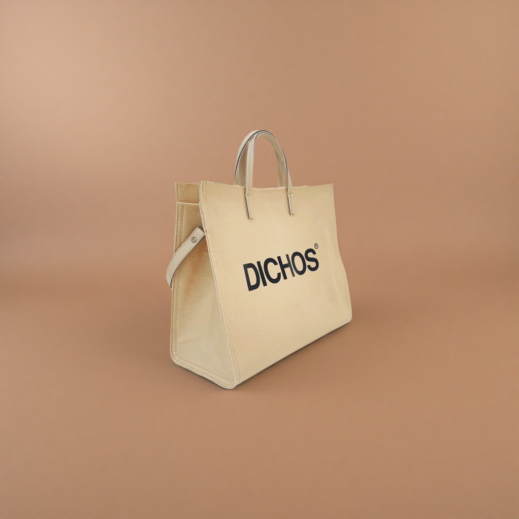 The front of the beige canvas tote bag is printed with the black word "DICHOS" Application Scenario