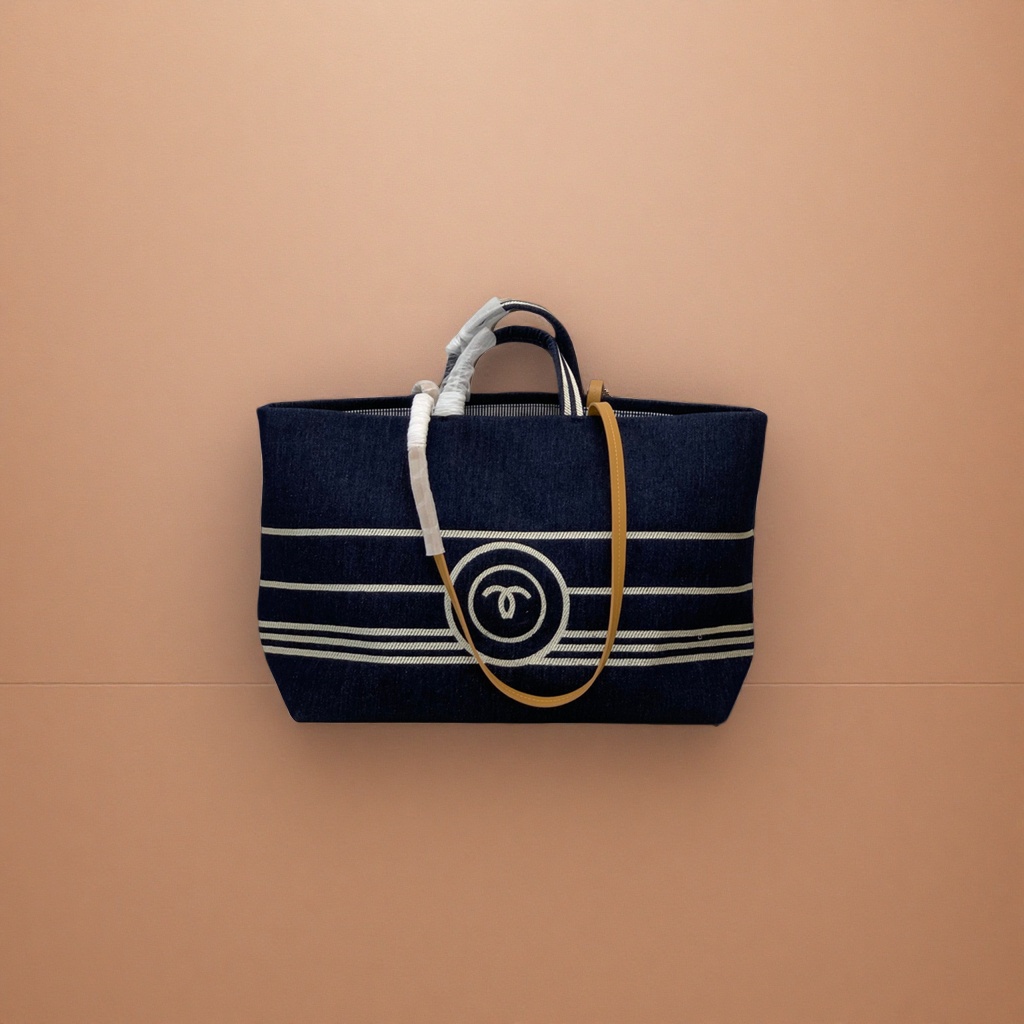 A dark blue striped canvas handbag with a beige shoulder strap and a white double C logo Specification image