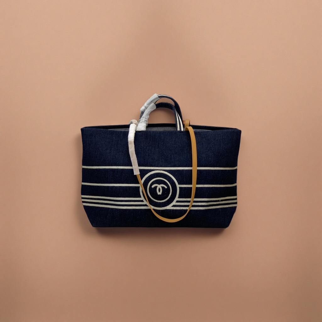 A dark blue striped canvas handbag with a beige shoulder strap and a white double C logo Application Scenario