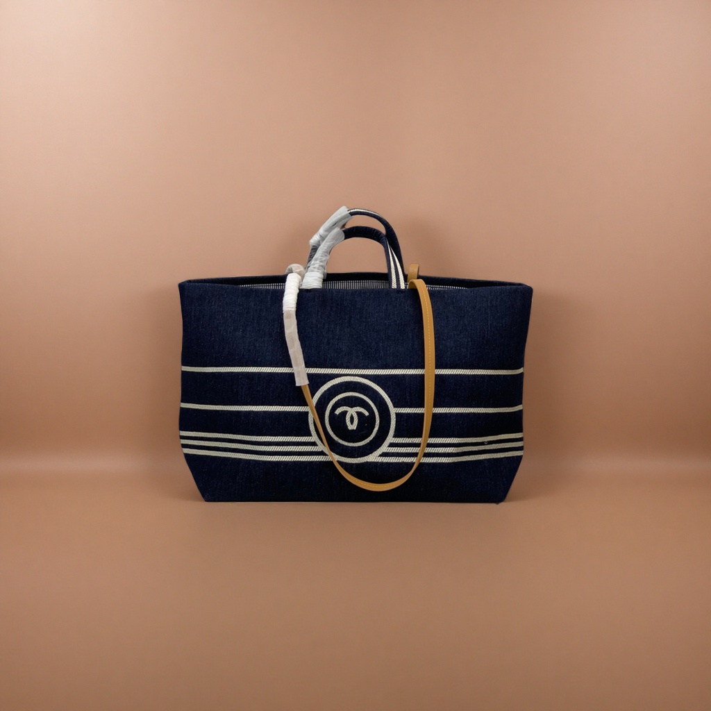 A dark blue striped canvas handbag with a beige shoulder strap and a white double C logo details Picture