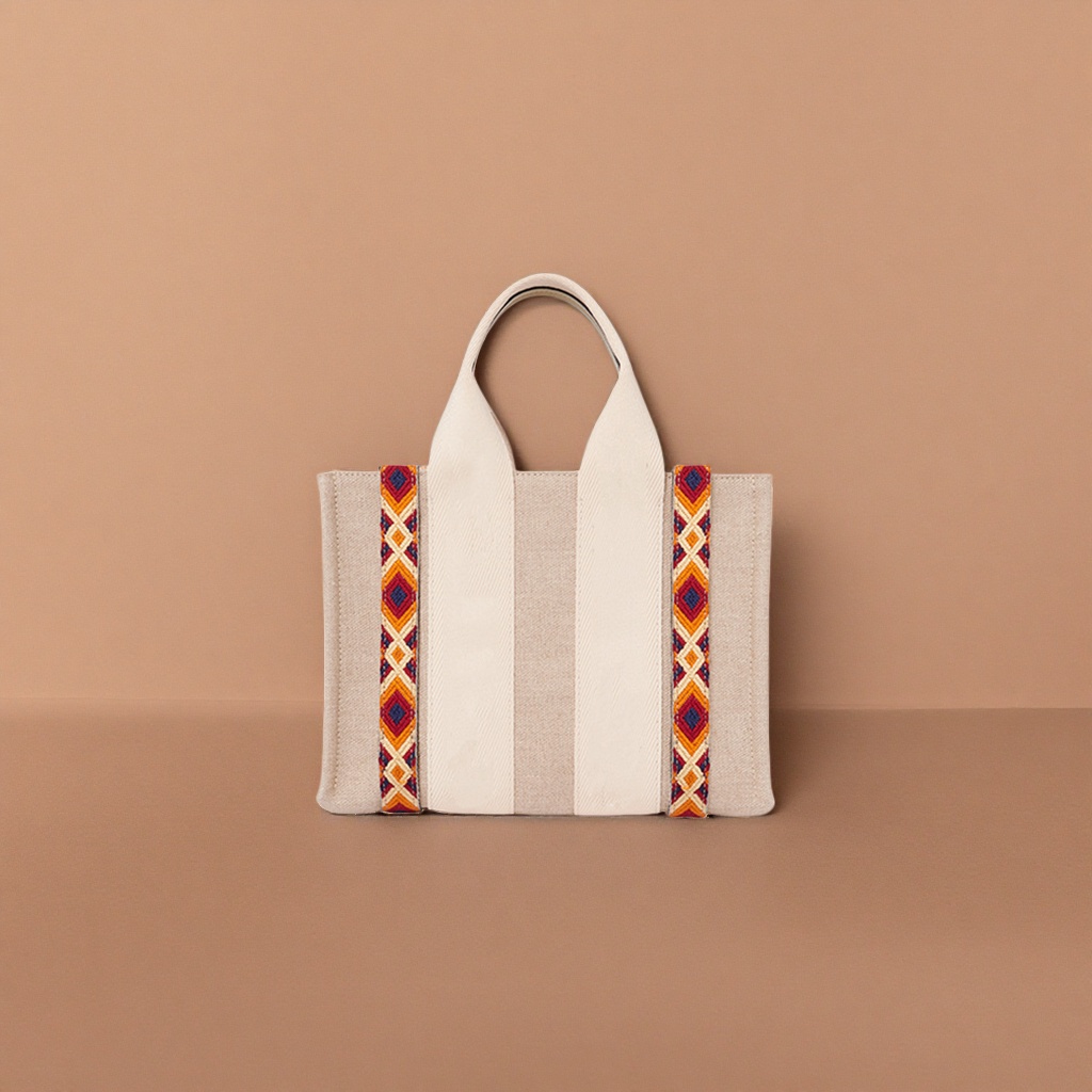 The beige canvas handbag has orange-red and blue geometric patterned webbing on both sides details Picture