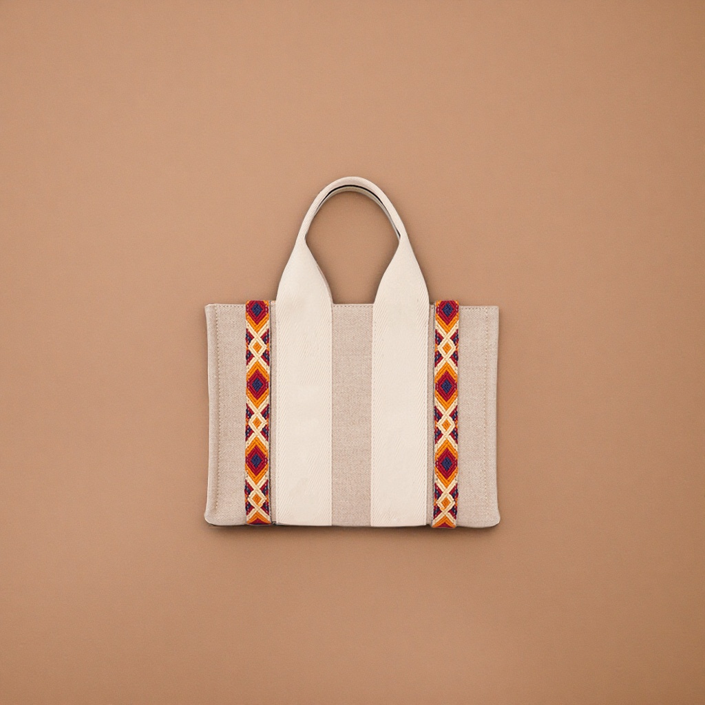 The beige canvas handbag has orange-red and blue geometric patterned webbing on both sides Specification image