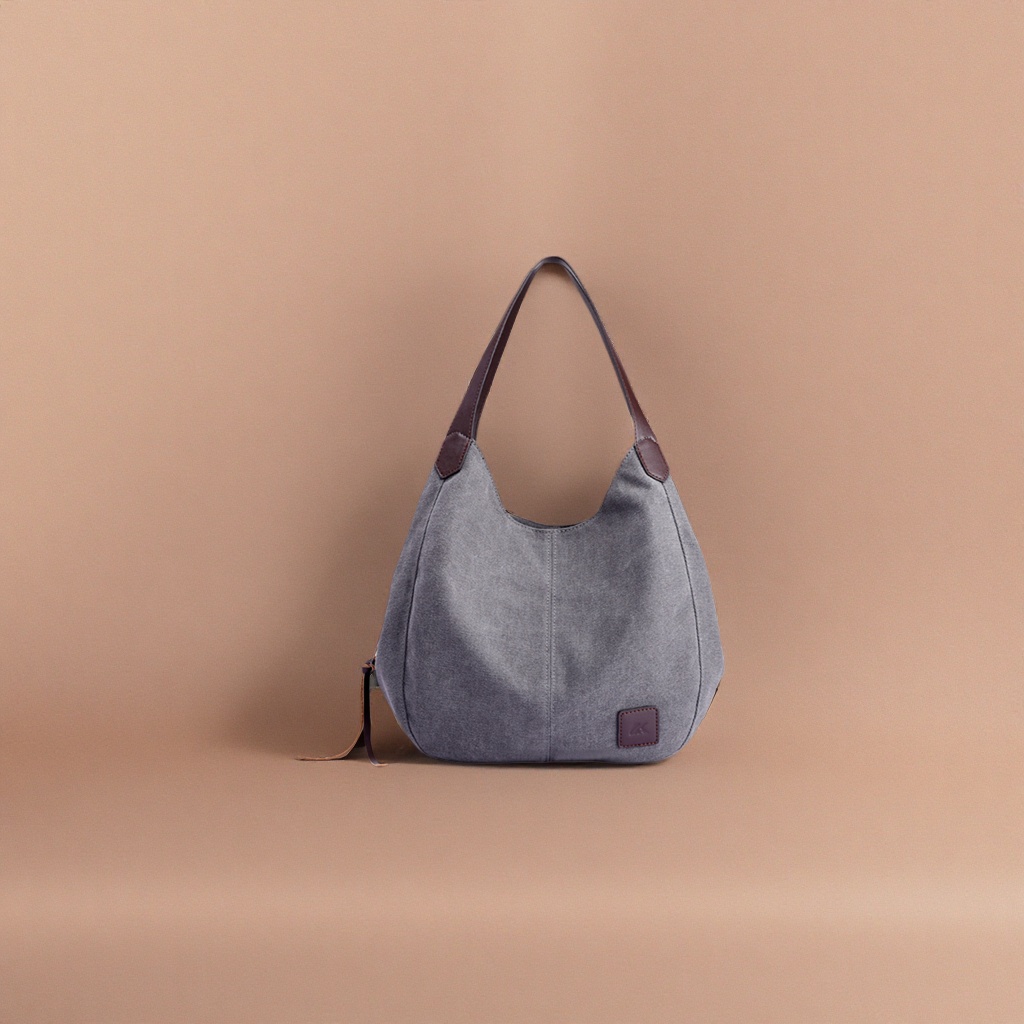 The grey canvas handbag is simple and versatile, convenient for commuting and shopping, and has a large capacity