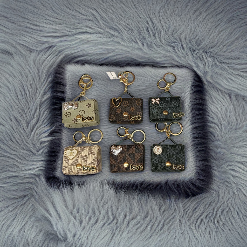 Six mini handbag keychains feature different patterns and decorative details Application Scenario