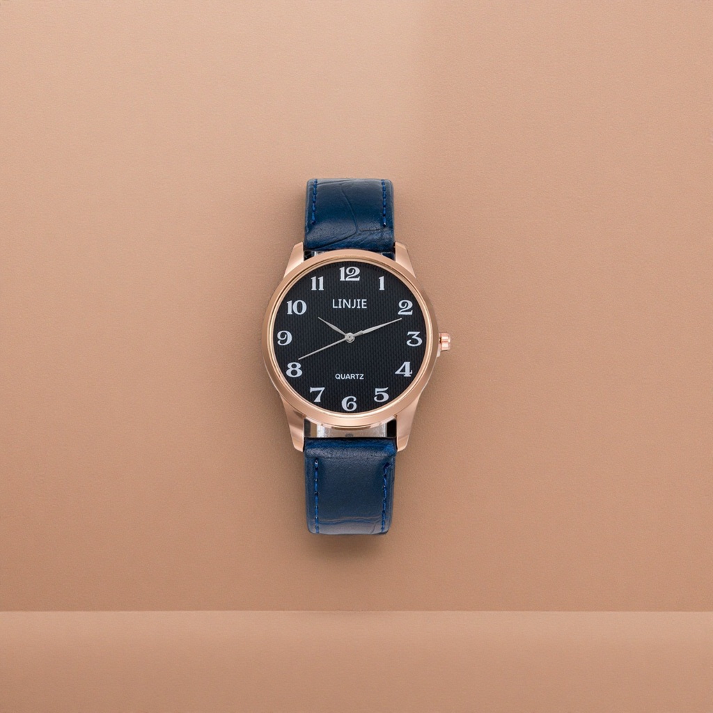 A ladies' watch with a blue leather strap, rose gold frame and black dial