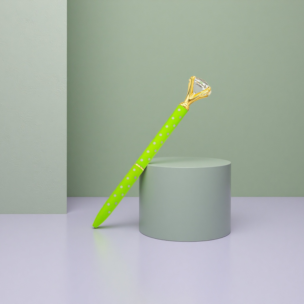 A gel pen with a green polka dot body and a golden diamond-encrusted cap