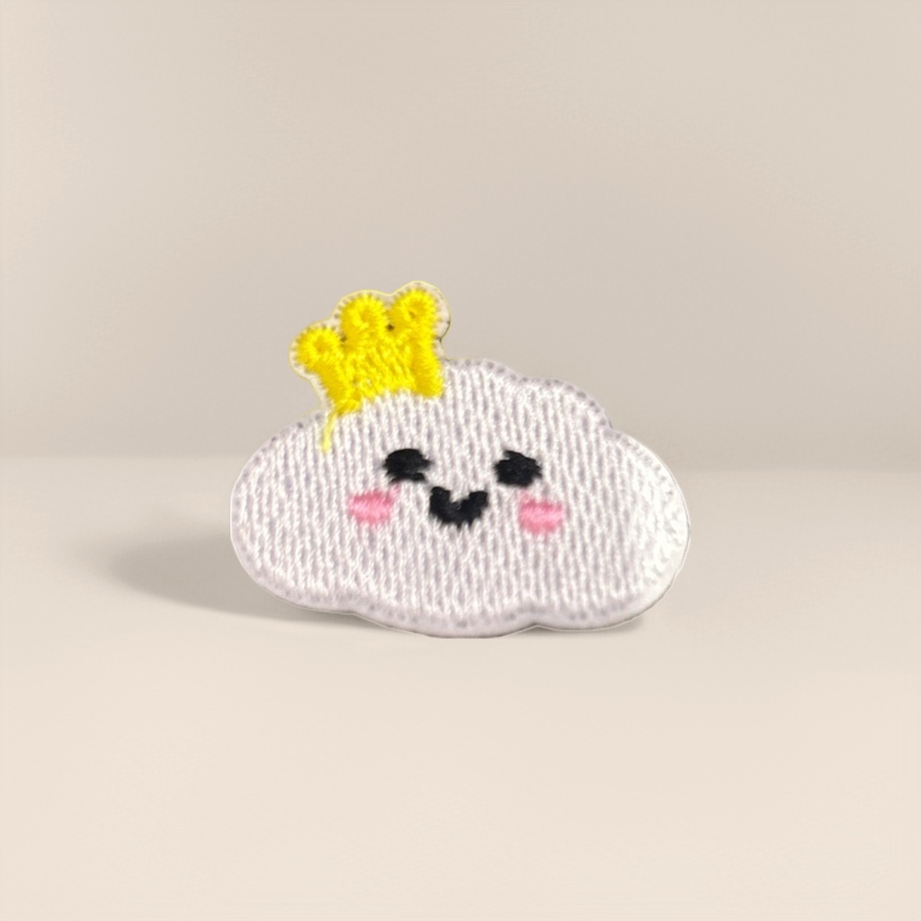 Grey striped background, pink cloud embroidered patches, wearing a small yellow crown, with black eyes and a smiling mouth details Picture