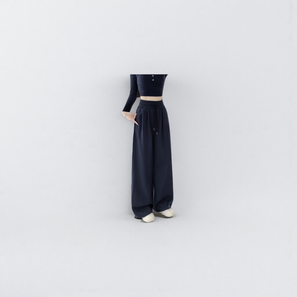 Navy blue high-waisted wide-leg pants for women paired with a black short top and white sports shoes
