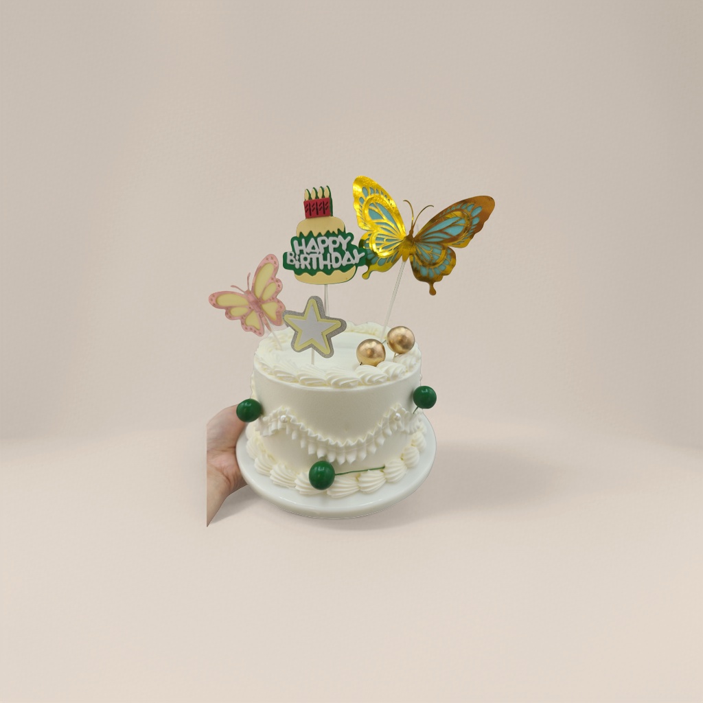 白色奶油生日蛋糕顶部金色粉色蝴蝶星星插牌金绿球饰