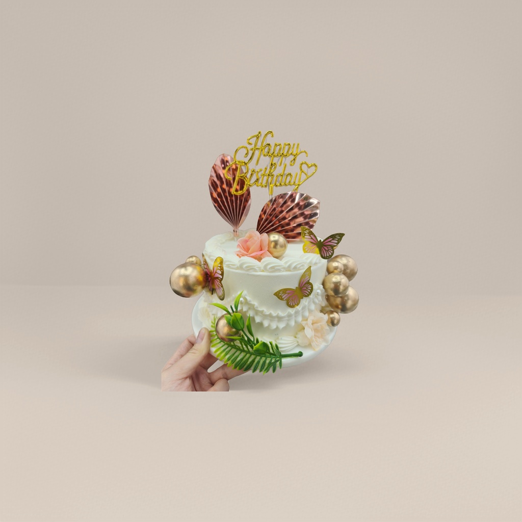 白色双层生日蛋糕配金色蝴蝶球体粉色花朵Happy Birthday插牌