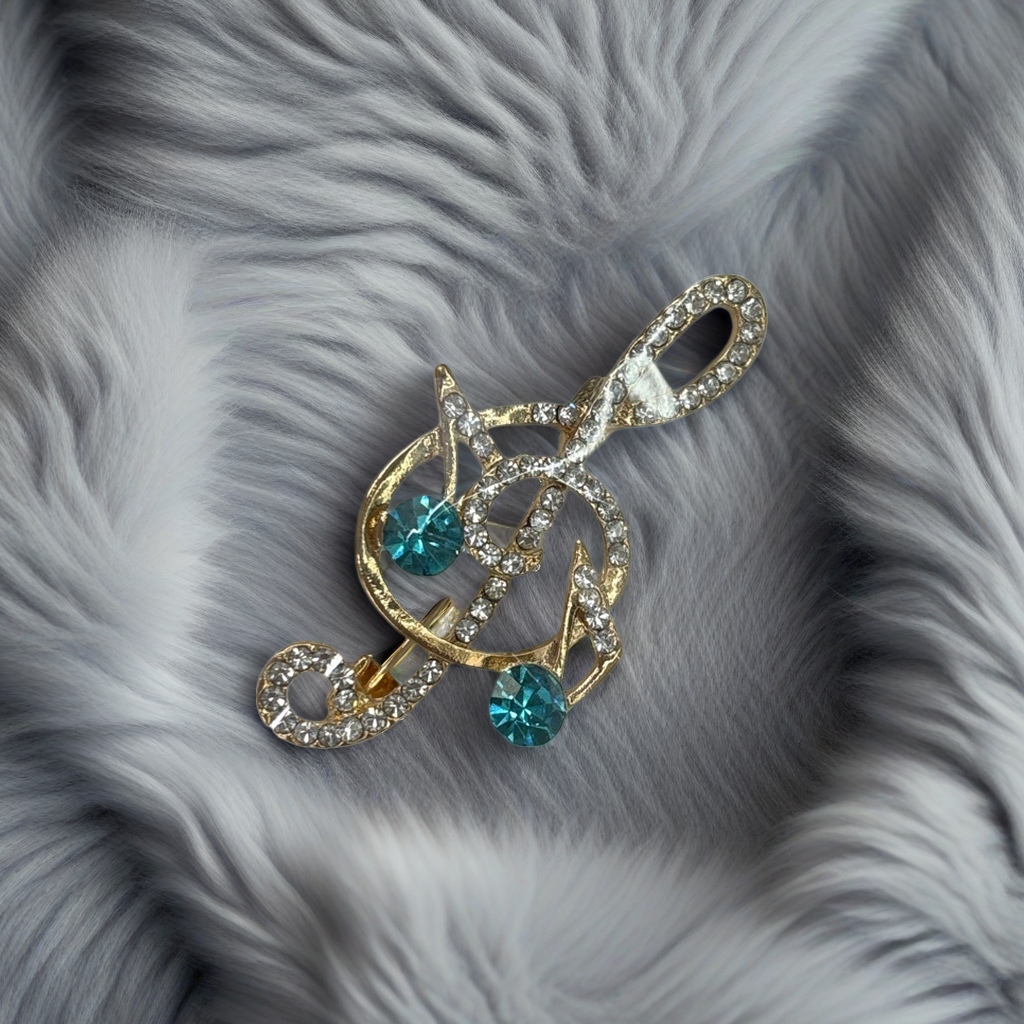 A golden note-shaped brooch set with blue and green transparent rhinestones and fashionable jewelry, wrapped in a white card Specification image