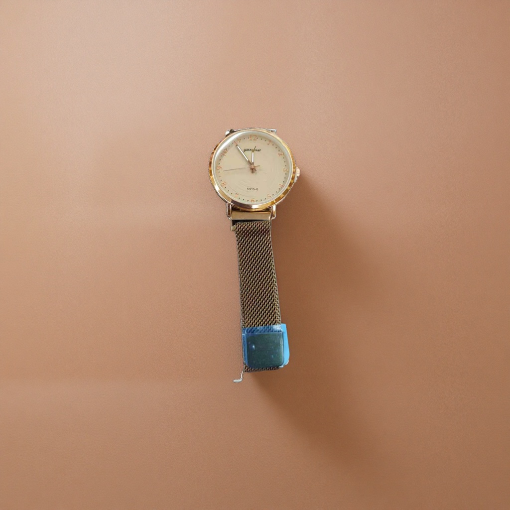 A simple and fashionable quartz watch for ladies with a golden case, beige dial and metal mesh strap details Picture