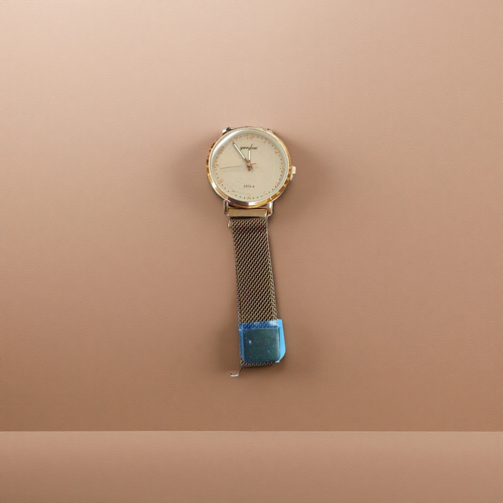 A simple and fashionable quartz watch for ladies with a golden case, beige dial and metal mesh strap