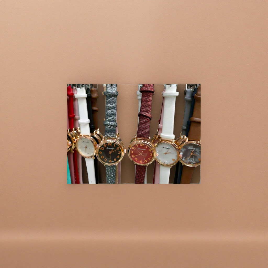 A ladies' watch with a golden case, a black Burgundy dial and a glitter pink strap