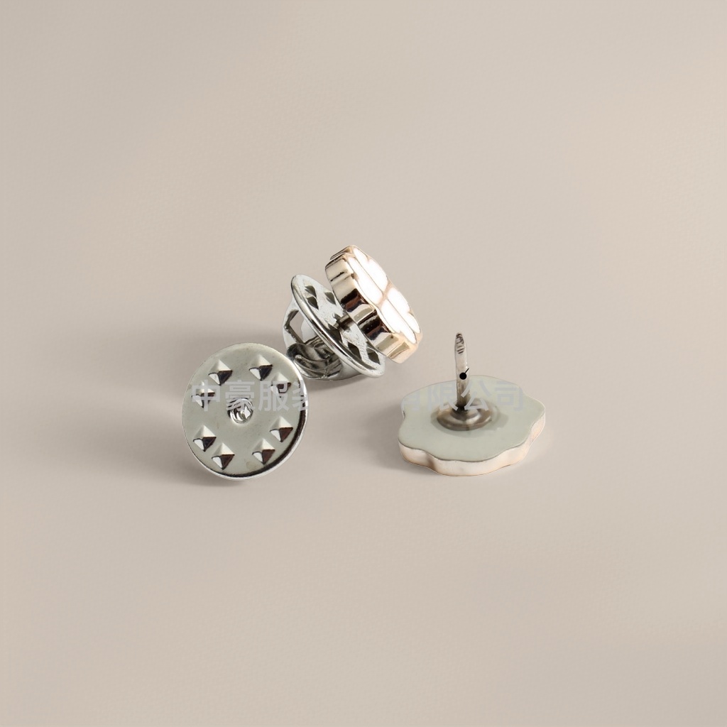 A combination of silver metal buttons and a plastic base